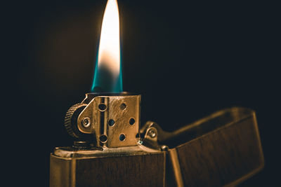 Close-up of illuminated lamp against black background