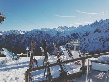 Ski lift over snowcapped mountains against sky