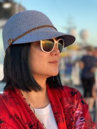 Close-up of woman wearing sunglasses and hat outdoors