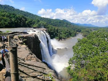 Scenic view of waterfall against sky