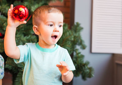 Portrait of cute boy holding plant