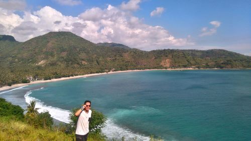 Man standing by sea against sky