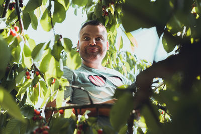 Portrait of smiling man in tree