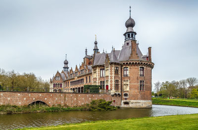 View of building by river against sky