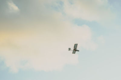 Low angle view of airplane flying in sky