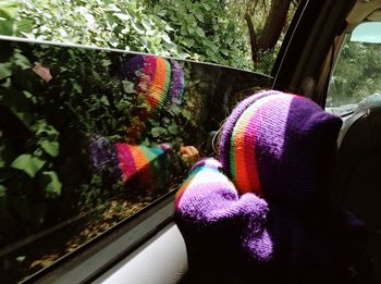 Rear view of person looking through car window