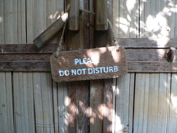 Close-up of text hanging on wood