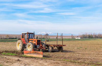 Tractor on field against sky