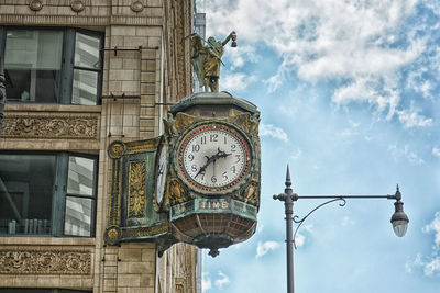 Low angle view of clock tower against sky