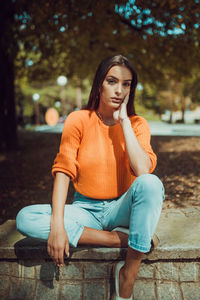 Portrait of young woman sitting on seat