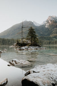 Scenic view of lake and mountains against clear sky