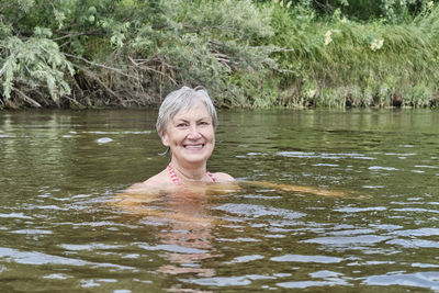 Young woman swimming in lake