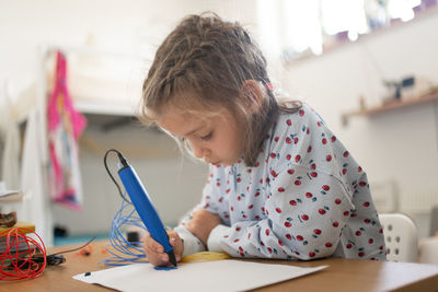 Side view of girl studying at home