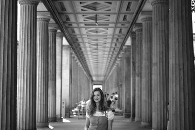 Full length portrait of woman against building