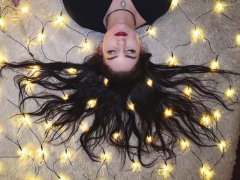 High angle portrait of woman with illuminated lights