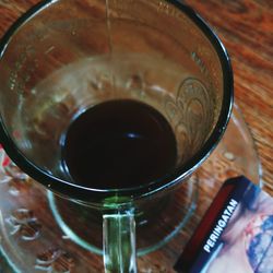 High angle view of coffee in glass on table