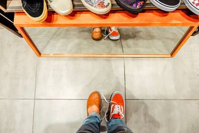 Low section of person standing on tiled floor