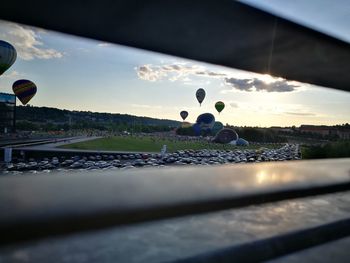 Surface level of balloons against sky during sunset
