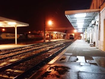 Illuminated railroad station platform at night