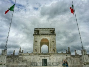 Low angle view of building against cloudy sky
