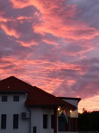 Low angle view of house against orange sky