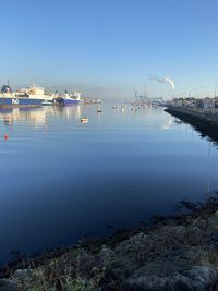 Boats in sea against clear sky