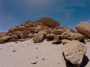 Rock formations on desert against sky