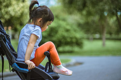 Side view of boy riding bicycle