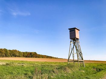 Tower on field against sky
