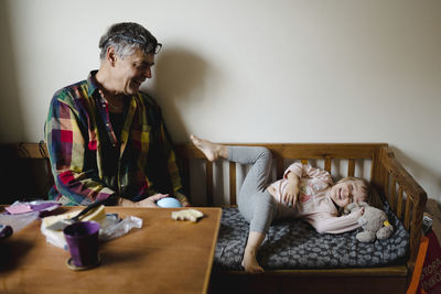 Grandfather and granddaughter having fun together