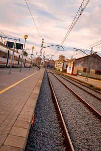 Railroad track against cloudy sky