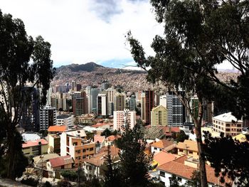 High angle view of buildings and trees against sky