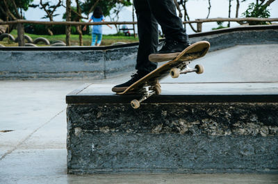 Low section of person skateboarding in park