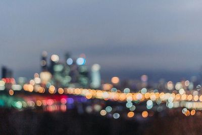 Defocused image of illuminated city at night