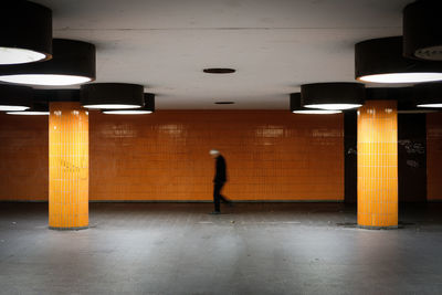 Side view blurred motion of man walking in subway