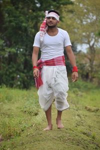 Full length portrait of man standing on field