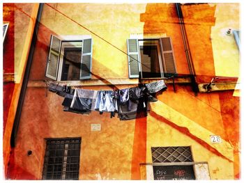 Low angle view of clothes drying against buildings