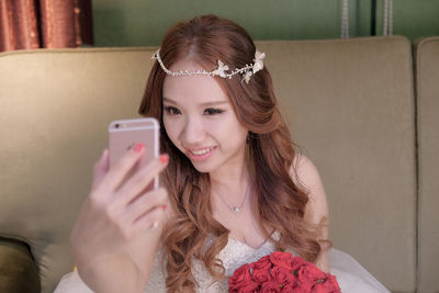 Bride taking selfie on mobile phone