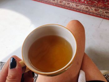 Midsection of person holding tea cup