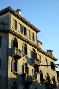 Low angle view of building against clear blue sky