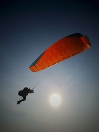 Low angle view of parachute in air against clear sky