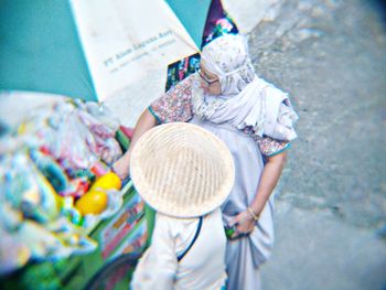 Low section of woman holding paper