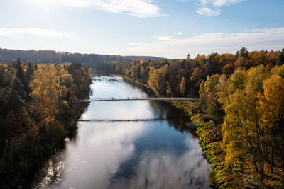 Pedestrian bridge over the river gauja near the devil cliff on a cloudy autumn day, krimulda, latvia