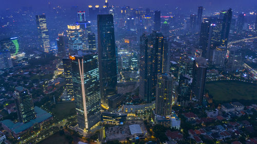 High angle view of illuminated buildings in city at night