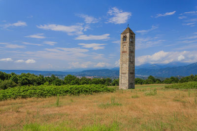 Tower on field against sky