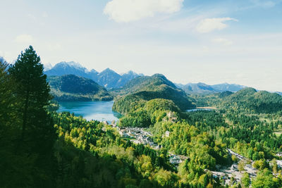 Scenic view of trees and mountains against sky