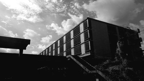 Low angle view of building against cloudy sky