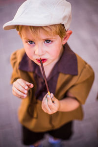 Portrait of cute boy holding colored pencil