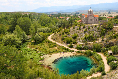 Scenic view of lake with buildings in background