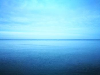 Scenic view of sea against blue sky